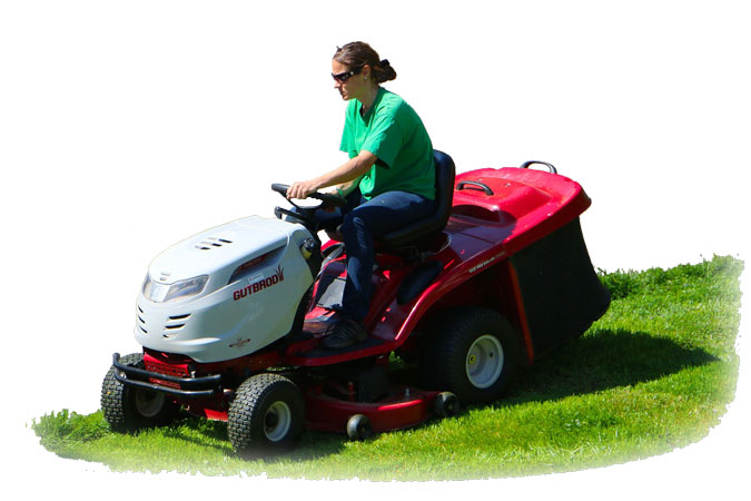 Photo of a Superyards employee cutting gras with a riding lawn mower